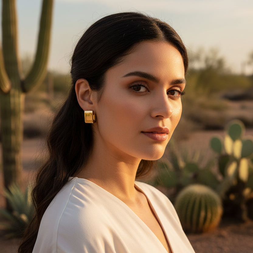 Gold square earrings on Latina model in dessert