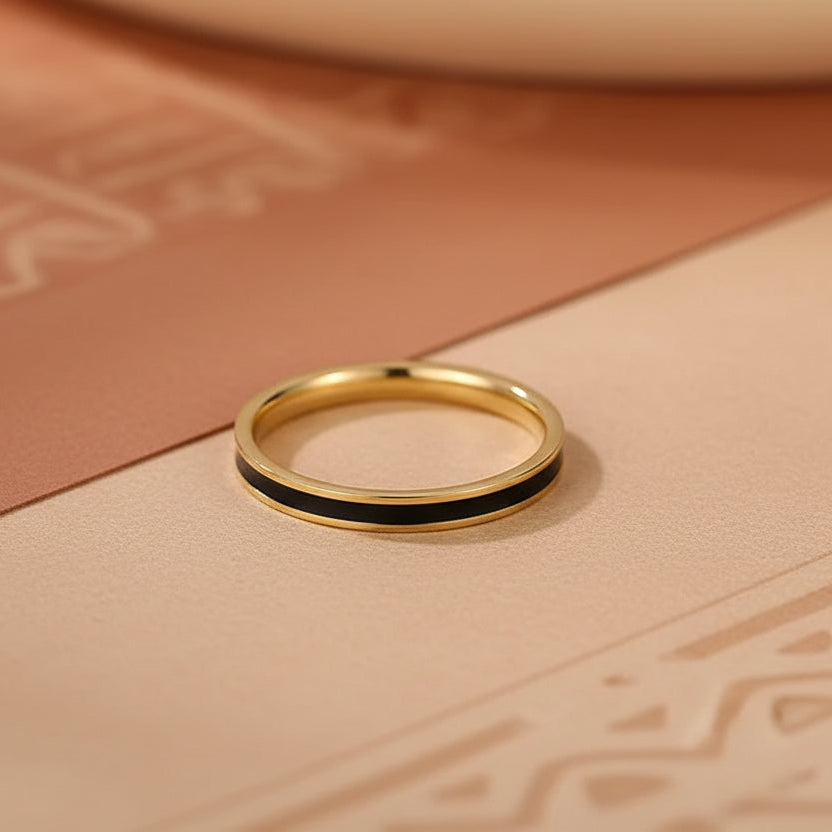 Three gold rings with different designs on a light background