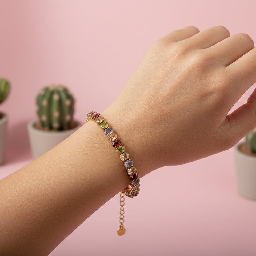 Multicolored beaded bracelet with gold chain on a white background
