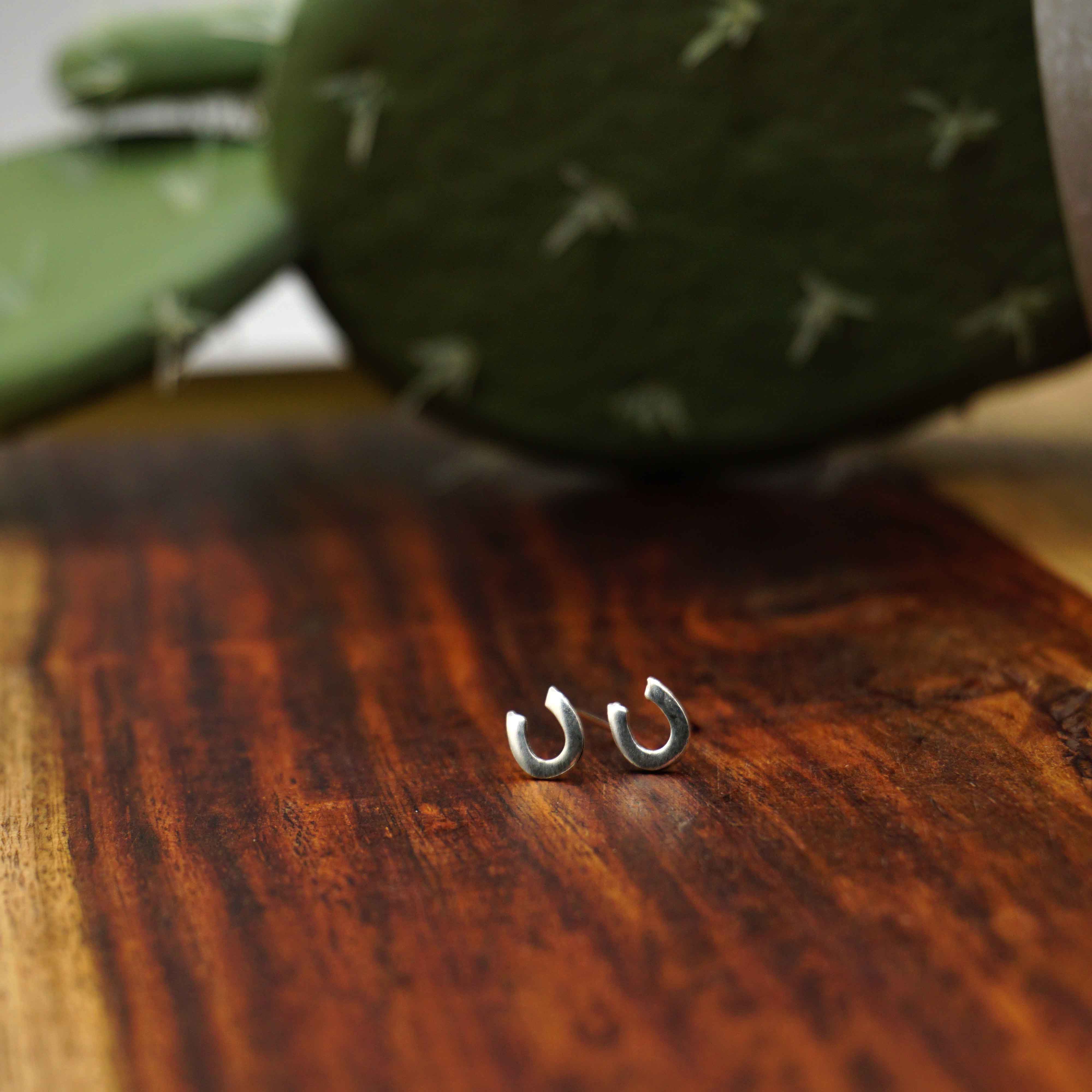 horseshoe sterling silver stud earrings. small dainty horseshoe earring stud posts are inspired by the lucky horseshoe symbol